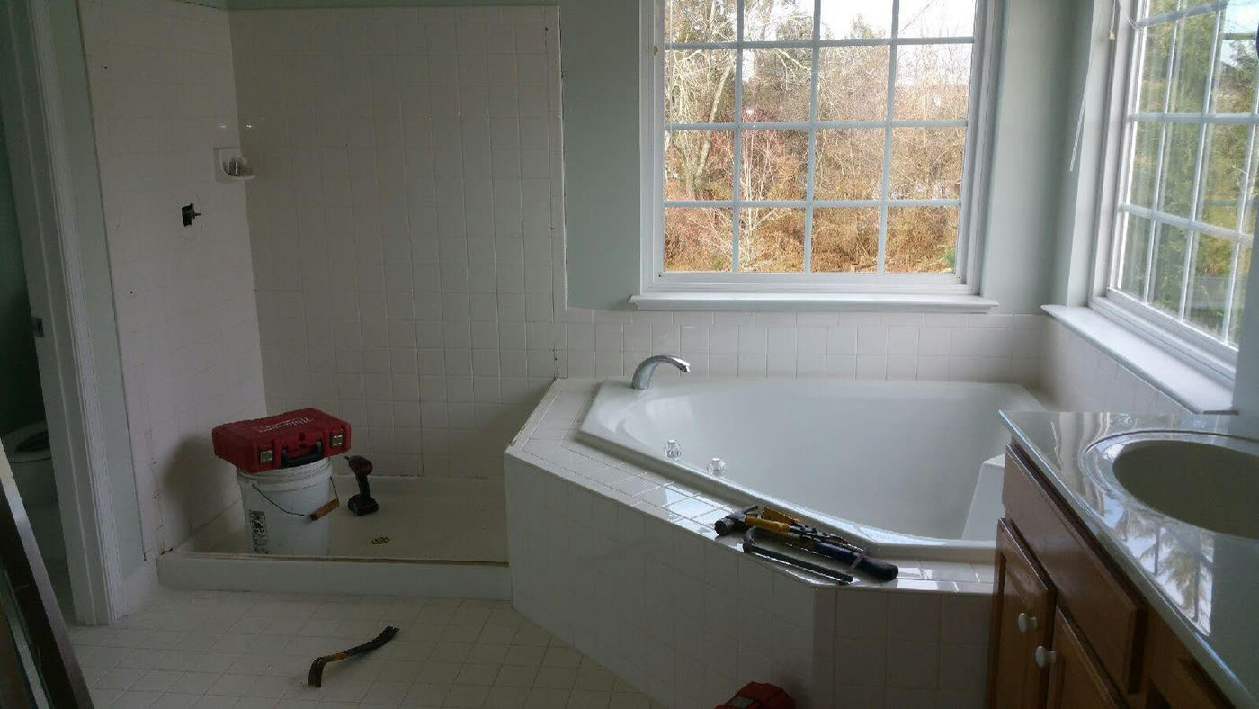 Bathroom with a corner tub and white tile